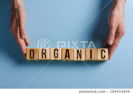 organic word on a blue background written on a wooden block. organic text on the table, concept. 104414856