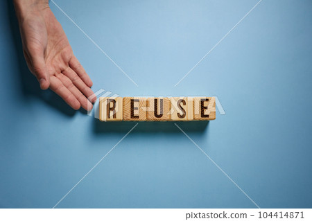 On a blue background, the surface of the white cubes with the inscription - REUSE 104414871