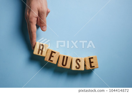 On a blue background, the surface of the white cubes with the inscription - REUSE On a blue background, the surface of the white cubes with the inscription - REUSE 104414872