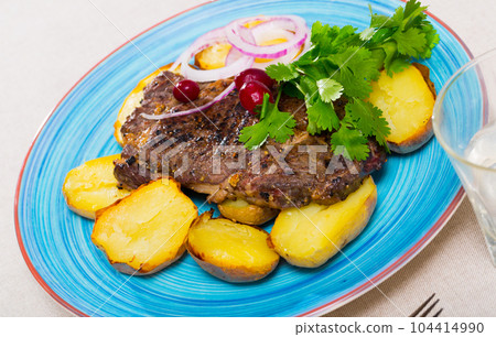 Juicy beefsteak served with baked potato Juicy beefsteak served with baked potato 104414990