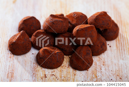 Chocolate candies truffles on light table 104415045