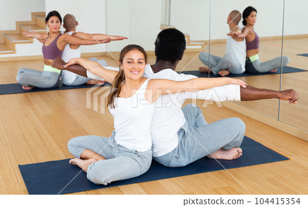 Couples practicing yoga with partner at studio Couples practicing yoga with partner at studio 104415354