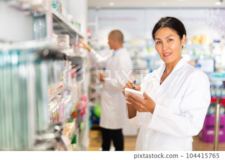 Woman doctor standing in chemist shop Woman doctor standing in chemist shop 104415765