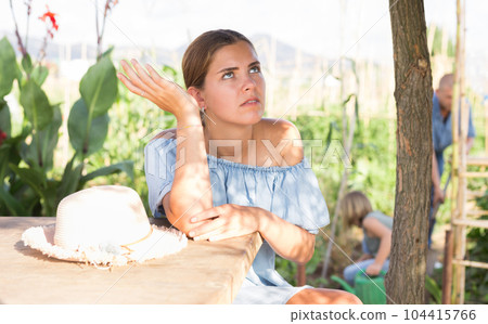 Family of three working in kitchen garden Family of three working in kitchen garden 104415766