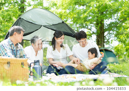 Three generation family enjoying camping Three generation family enjoying camping 104415833