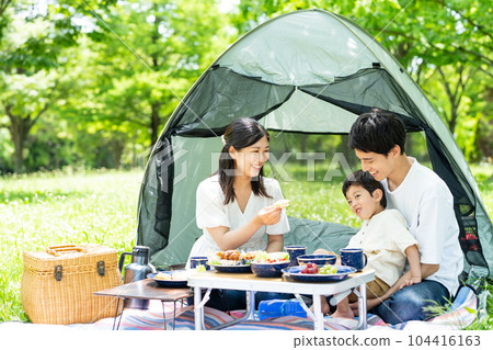 Young family enjoying camping 104416163