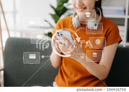 Woman hand using a laptop, smartphone and tablet and writing notebook at the office of her business online shopping. In home with virtual icon Woman hand using a laptop, smartphone and tablet and writing notebook at the office of her business online shopping. In home with virtual icon 104416750