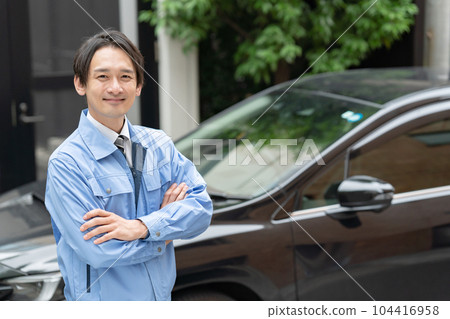 Man in work clothes car inspection Man in work clothes car inspection 104416958