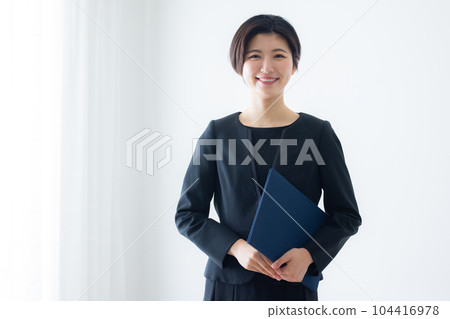 A woman in a black suit A woman in a black suit 104416978