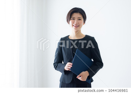 A woman in a black suit 104416981