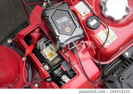 Recharging the battery of a snow blower 104418243
