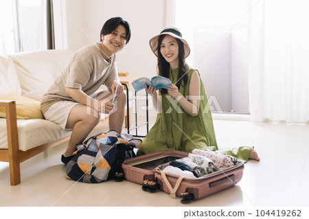 A couple preparing for a trip / a couple planning A couple preparing for a trip / a couple planning 104419262