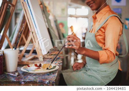 Beautiful American African artist woman painting in art studio at the university classroom Beautiful American African artist woman painting in art studio at the university classroom 104419481