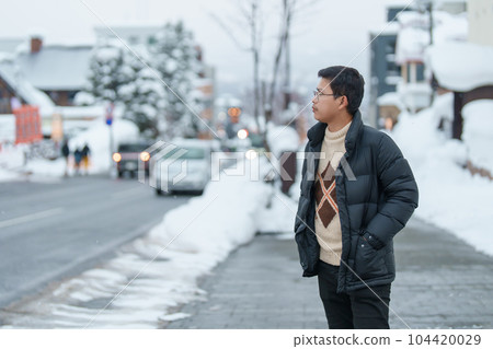 man tourist sightseeing in Niseko city with Snow in winter season. landmark and popular for attractions in Hokkaido, Japan. Travel and Vacation concept man tourist sightseeing in Niseko city with Snow in winter season. landmark and popular for attractions in Hokkaido, Japan. Travel and Vacation concept 104420029