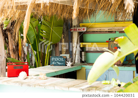 Counter of sunny surf hire shop on beach with radio and signs to beach and pool Counter of sunny surf hire shop on beach with radio and signs to beach and pool 104420031