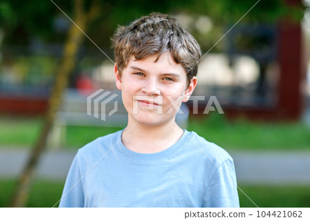 Portrait of positive preteen school kid boy. Beautiful happy child looking at the camera. Schoolboy smiling. 104421062