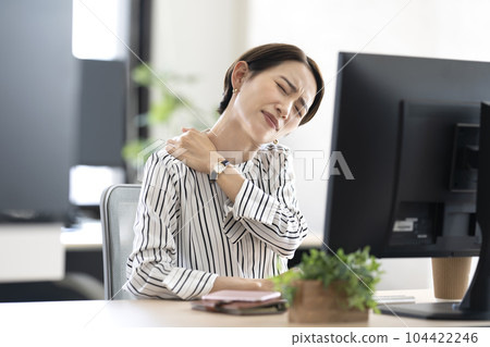 A woman with stiff shoulders A woman with stiff shoulders 104422246