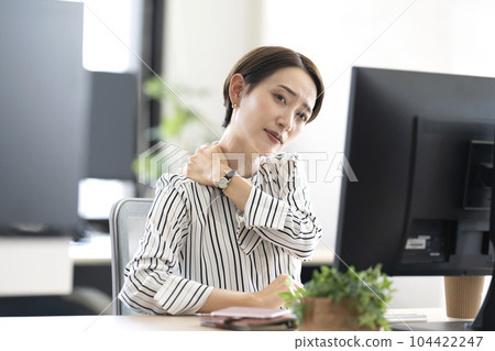 A woman with stiff shoulders A woman with stiff shoulders 104422247