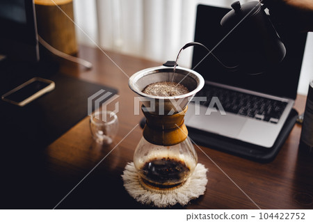 Drip coffee on the desk in the morning 104422752