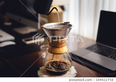Drip coffee on the desk in the morning 104422758