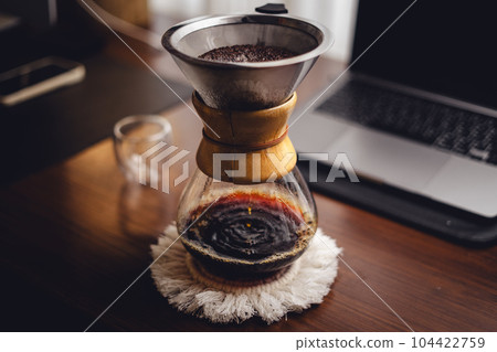 Drip coffee on the desk in the morning 104422759