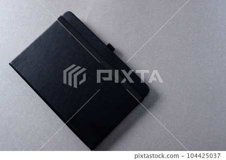 Close up of black notebook with copy space on grey background Close up of black notebook with copy space on grey background 104425037
