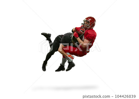 Dynamic image of two men in uniform american football players in motions on field during tense game against white background 104426839
