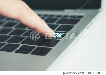 Finger pressing at OK botton on the keyboard. decision concept. 104427016