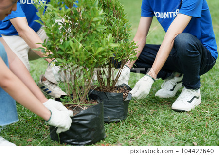Young Asian Volunteers with garbage bags cleaning park area. Ecology, Charitable organization concept 104427640