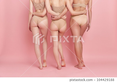 Cropped image of female body, buttocks and legs against pink studio background. models in underwear. Depilation, epilation, anti-cellulite massage Cropped image of female body, buttocks and legs against pink studio background. models in underwear. Depilation, epilation, anti-cellulite massage 104429188