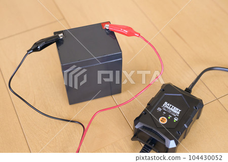 12V lead battery and charger during charging 104430052