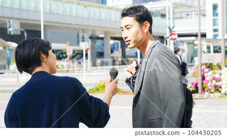 A man receiving a street interview 104430205