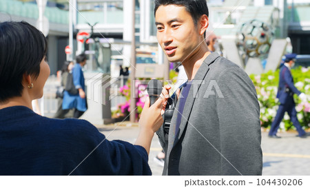 A man receiving a street interview 104430206