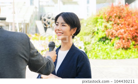 A woman undergoing a street interview 104430211