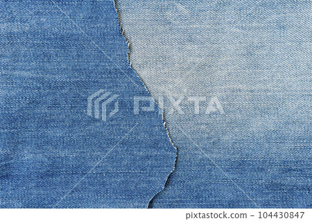 Ripped denim fabric close-up 104430847