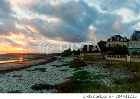 Sunrise view of coastal street of Grandcamp Maisy, a scenic French coastal town in Normandy, with fishing port, sandy beaches, and maritime traditions. Sunrise view of coastal street of Grandcamp Maisy, a scenic French coastal town in Normandy, with fishing port, sandy beaches, and maritime traditions. 104431216