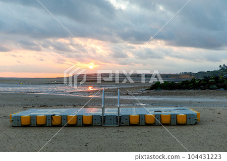 Sunrise view of coastal street of Grandcamp Maisy, a scenic French coastal town in Normandy, with fishing port, sandy beaches, and maritime traditions. Sunrise view of coastal street of Grandcamp Maisy, a scenic French coastal town in Normandy, with fishing port, sandy beaches, and maritime traditions. 104431223