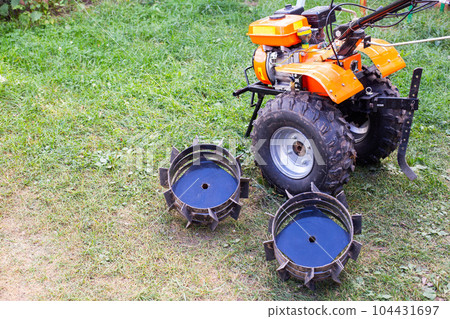 lugs complete with walk-behind tractor instead of wheels for better cross-country ability of the motor cultivator. Copy space for text 104431697