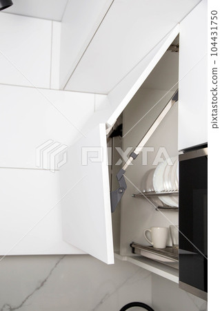 The modern lifting mechanism of a facade of a door with the closer. Furniture kitchen fittings 104431750