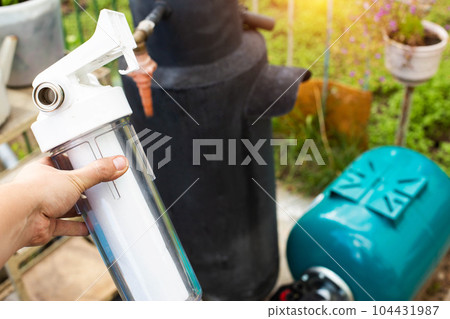 Filtration of water from a well with a sand and dirt filter. Water supply in the country. Filtration of water from a well with a sand and dirt filter. Water supply in the country. 104431987