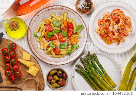 Italian pasta adorned with fresh tomatoes and aromatic basil 104432168
