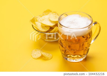 A tempting snack of beer and chips A tempting snack of beer and chips 104432216
