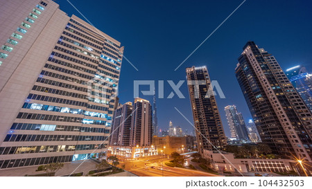 Aerial panoramic view to Dubai downtown and difc skyscrapers day to night timelapse. Aerial panoramic view to Dubai downtown and difc skyscrapers day to night timelapse. 104432503