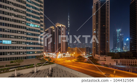 Aerial panoramic view to Dubai downtown and difc skyscrapers all night timelapse. 104432504