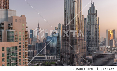 Aerial view of Dubai International Financial Centre district skyscrapers night to day timelapse 104432536