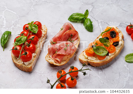Sandwich set of bruschetta with juicy tomatoes, cheese and prosciutto Sandwich set of bruschetta with juicy tomatoes, cheese and prosciutto 104432635
