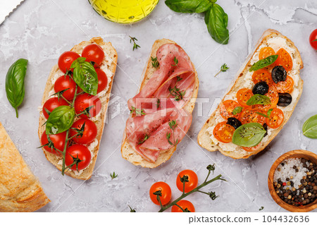 Sandwich set of bruschetta with juicy tomatoes, cheese and prosciutto Sandwich set of bruschetta with juicy tomatoes, cheese and prosciutto 104432636
