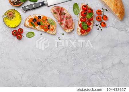 Sandwich set of bruschetta with juicy tomatoes, cheese and prosciutto Sandwich set of bruschetta with juicy tomatoes, cheese and prosciutto 104432637