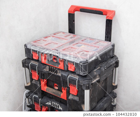 A modern set of drawers on a trolley for storing and storing a large number of tools, close-up 104432810