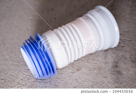 corrugated pipe for connecting the toilet in the toilet. Detail in plumbing. Close-up 104433038